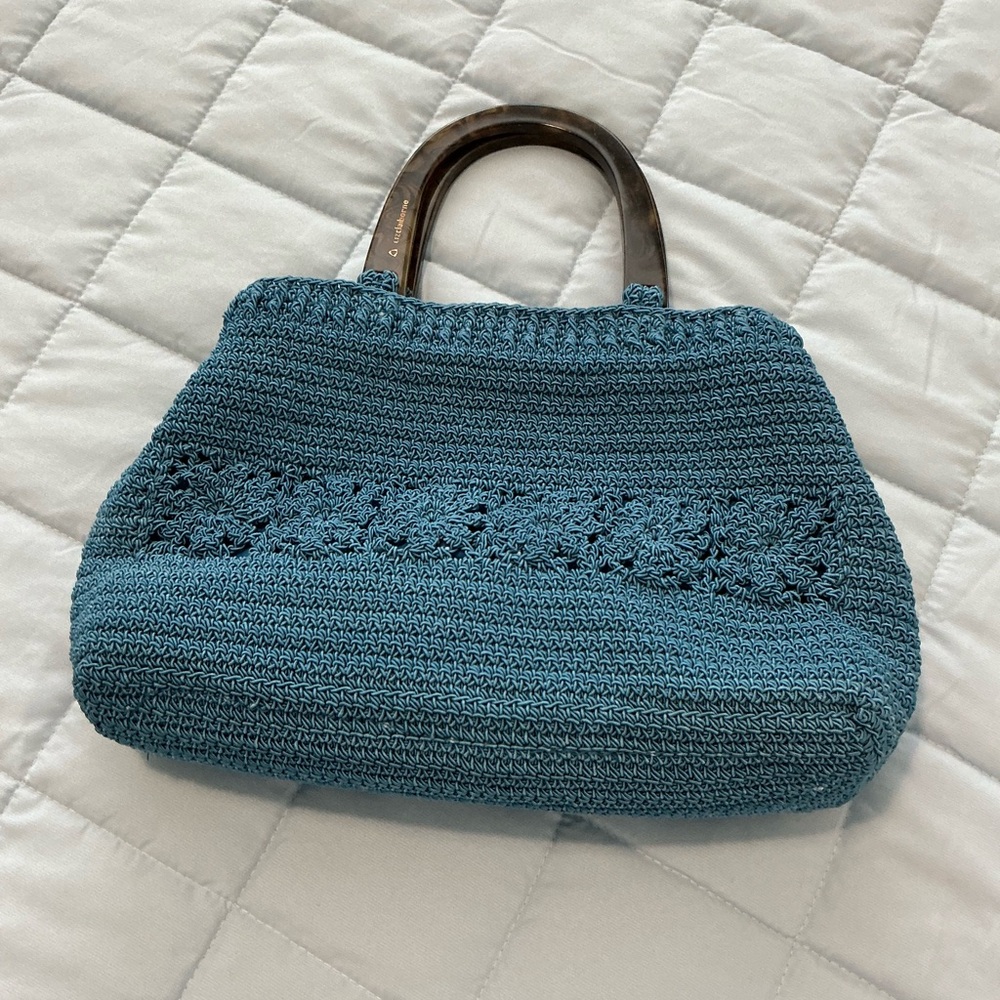 Darker teal purse with sharp green lining.